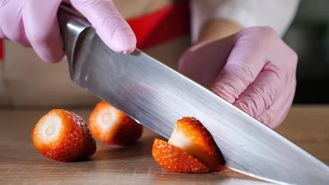 Chef cutting up strawberries